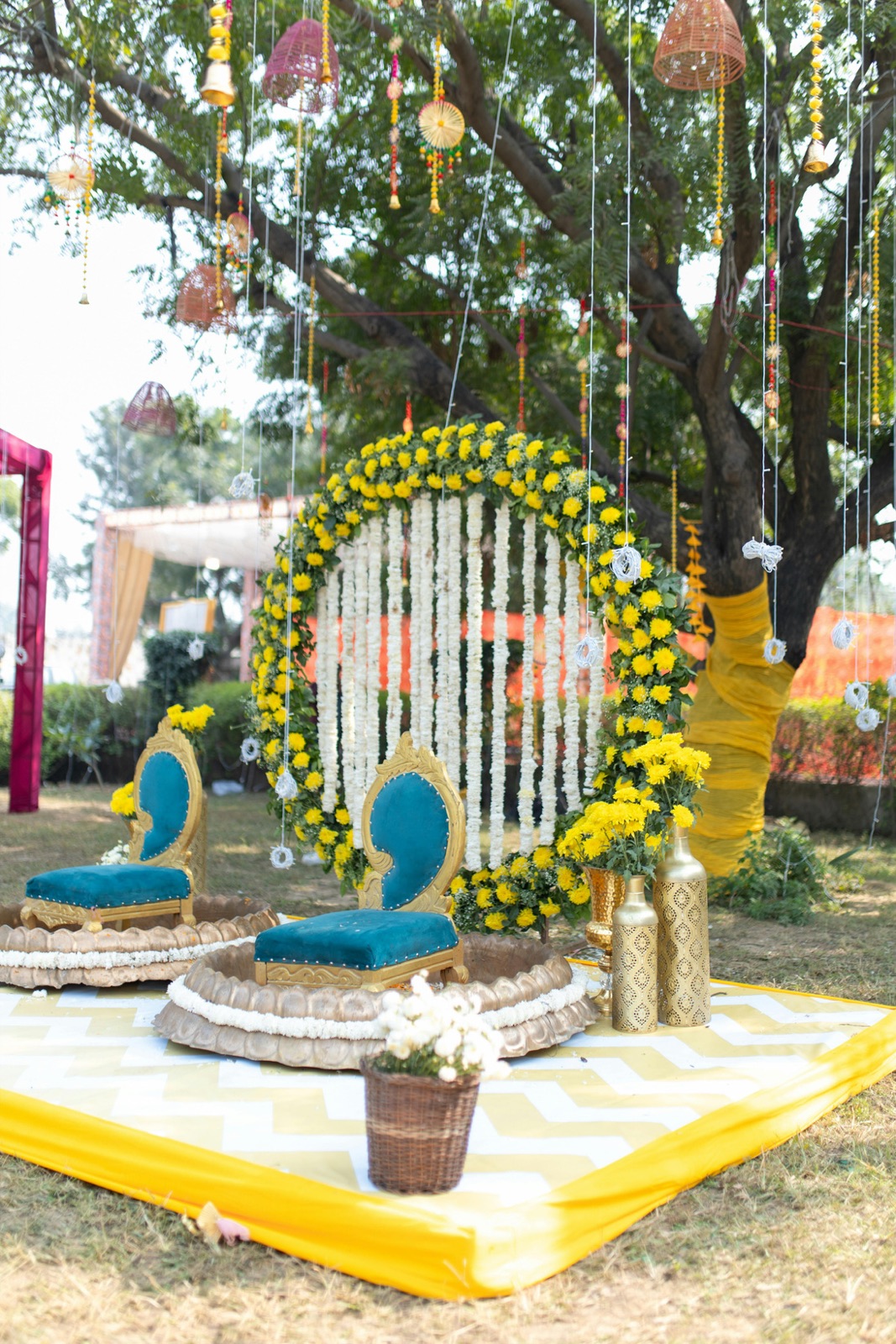 Haldi ceremony setup with marigold ring and teal chairs