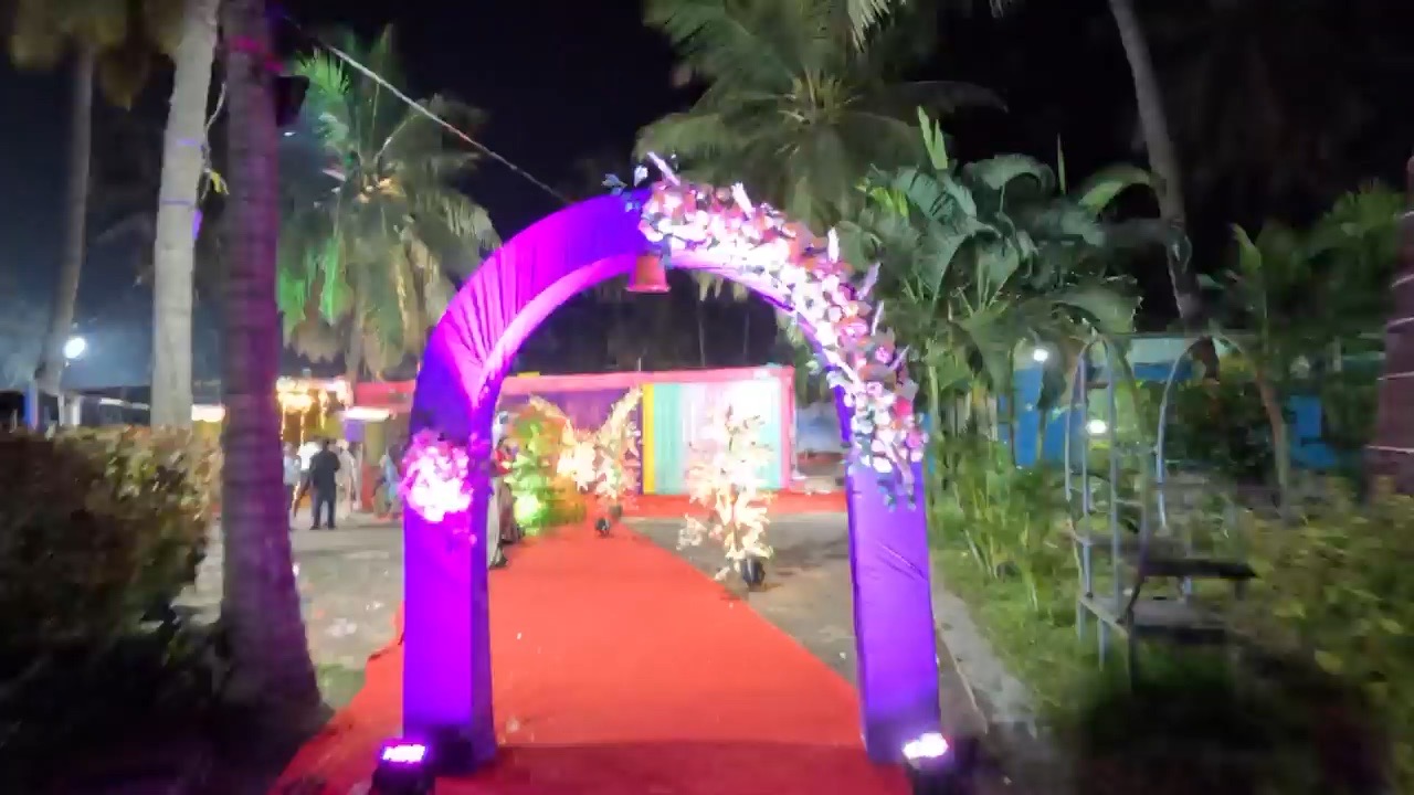 Purple floral arch with red carpet